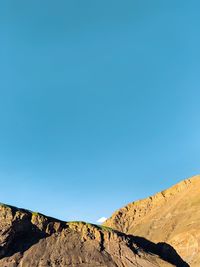 Scenic view of mountains against clear blue sky