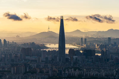 Buildings in city during sunset