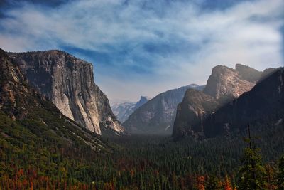 Scenic view of mountains against cloudy sky