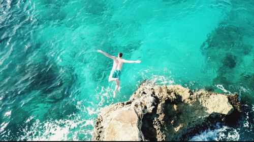 High angle view of woman swimming in sea