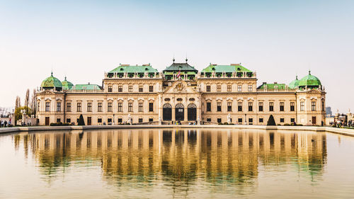 View of building in lake against sky