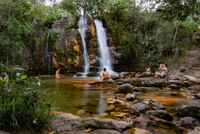 People at waterfall in forest