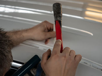 Close-up of man holding hands on table