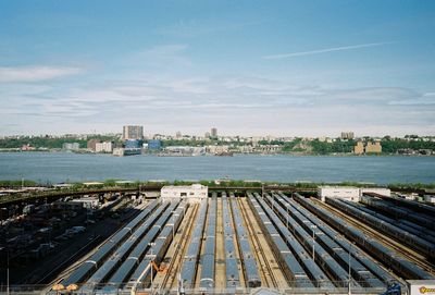 High angle view of railroad tracks by buildings in city against sky, new york city