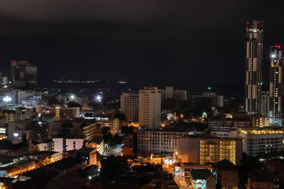 High angle view of illuminated buildings against sky at night