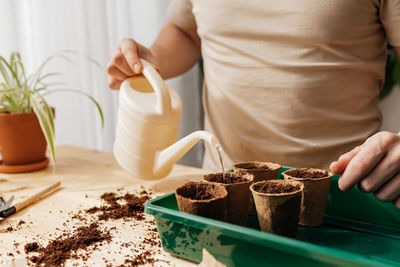 Midsection of man planting sapling