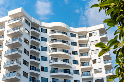 Low angle view of an apartment building with balconies. residential real estate.