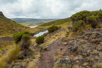 African landscape with lake ellis against a mountain background at chogoria route, mount kenya