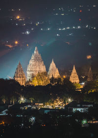 Illuminated temple building against sky at night