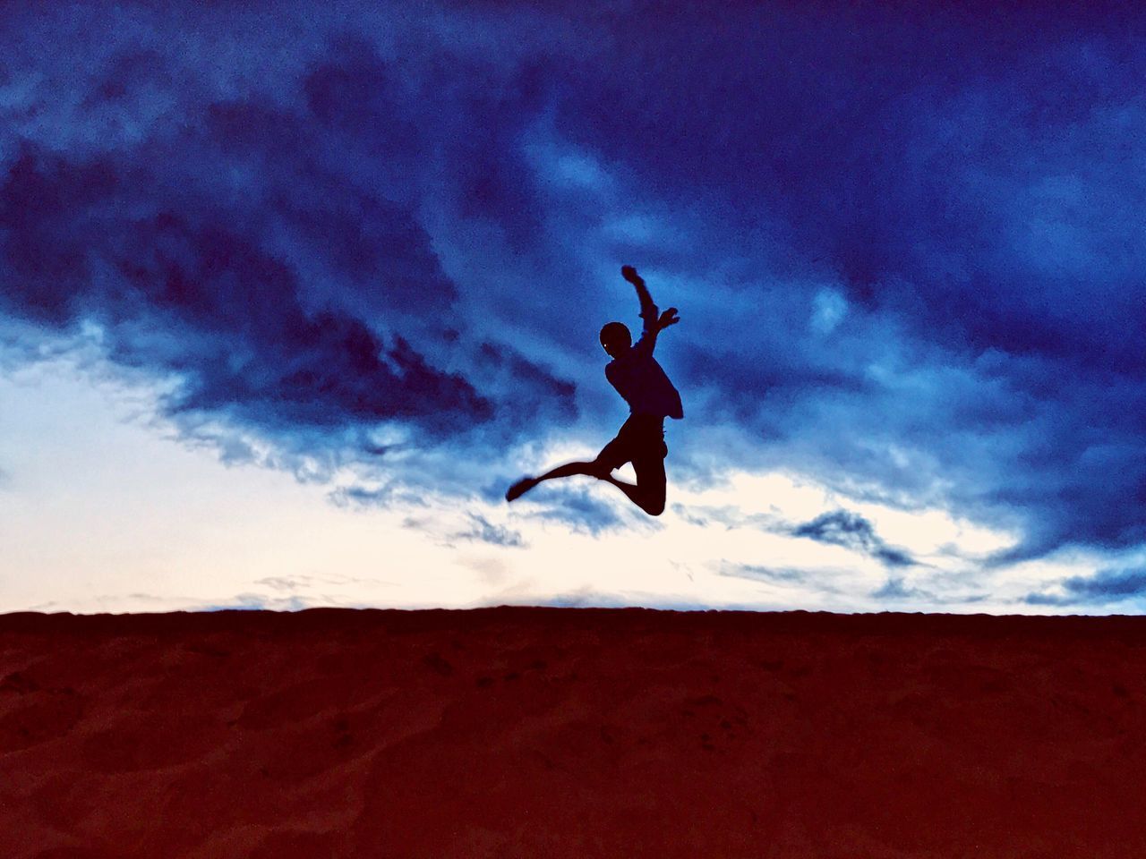 SILHOUETTE MAN JUMPING AGAINST SKY