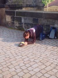 Portrait of boy on sidewalk