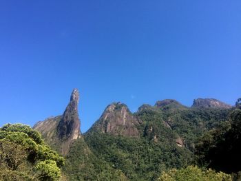 Scenic view of mountains against clear blue sky