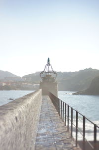 Pier over sea against clear sky