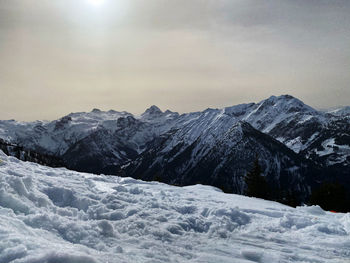 Scenic view of snow covered mountains against sky