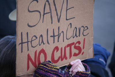 Close-up of hand holding placard with message during protest