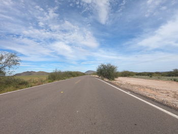 Empty road along countryside landscape