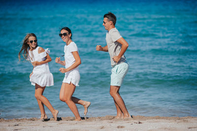 Friends standing at beach