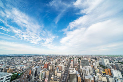 Aerial view of city and buildings against sky