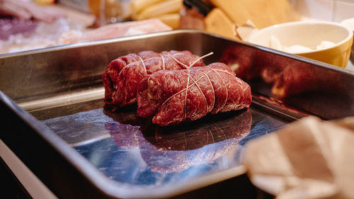 Close-up of prepared beef roulade in casserole dish on table