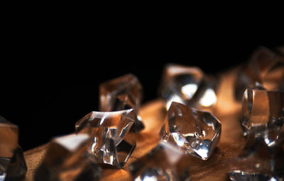 Close-up of wine glass on table against black background