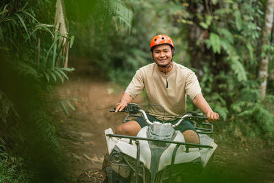 Portrait of young man riding bicycle