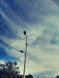 Low angle view of electricity pylon against sky