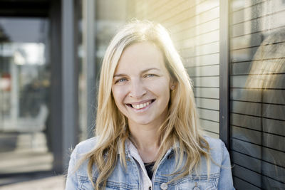 Portrait of smiling young woman with long hair