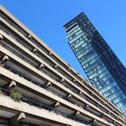 Low angle view of modern building against blue sky