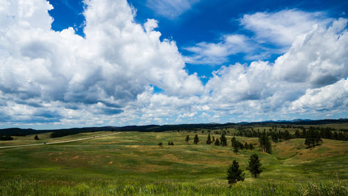 Panoramic shot of countryside landscape against cloudy sky