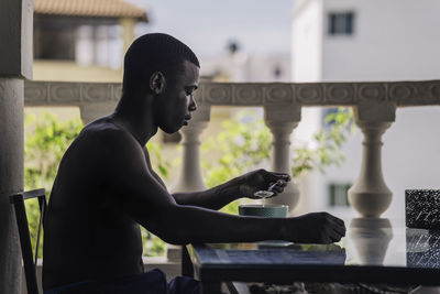 Side view of man using mobile phone