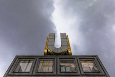 Low angle view of building against cloudy sky