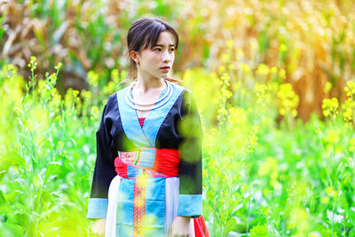 Teenage girl standing on field 