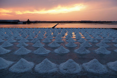 Scenic view of beach against sky during sunset