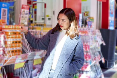 Young woman standing at store