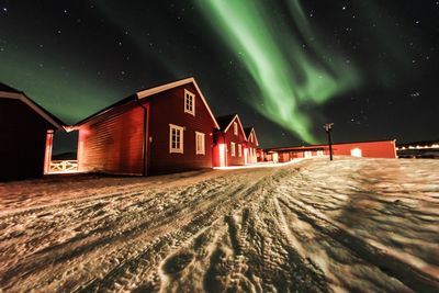 View of illuminated building against sky at night during winter