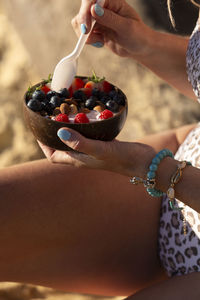 Cropped hand of woman holding cake