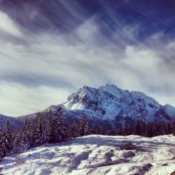 Scenic view of snow covered mountains against sky