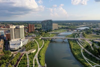 High angle view of river amidst buildings against sky