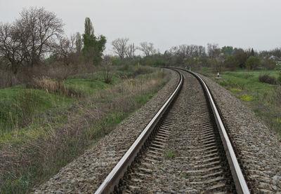 Railroad tracks in grassy landscape