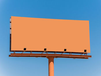 Low angle view of crane against clear blue sky