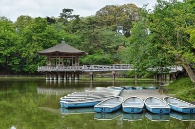 Built structure by lake against trees