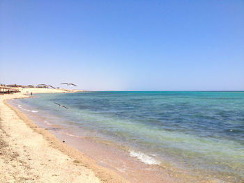 Scenic view of sea against clear blue sky