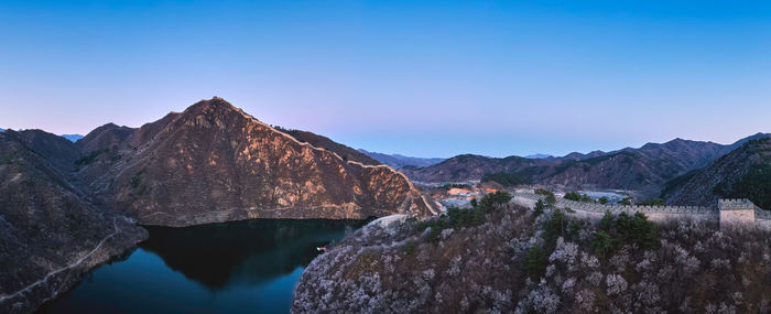 Panoramic view of rocks and mountains against blue sky