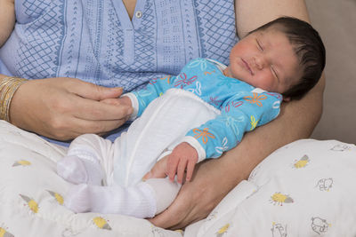 Close-up of baby sleeping on bed