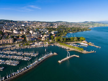 High angle view of townscape by sea against sky