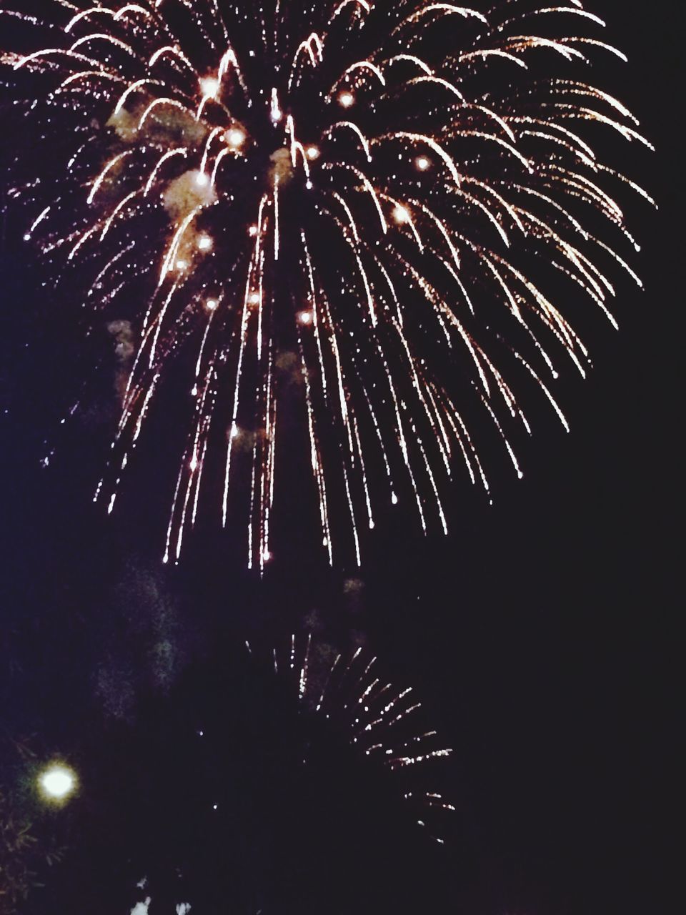 night, firework display, illuminated, celebration, exploding, long exposure, low angle view, arts culture and entertainment, firework - man made object, motion, glowing, sparks, event, firework, entertainment, sky, blurred motion, celebration event, outdoors, awe