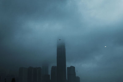 Low angle view of buildings against cloudy sky