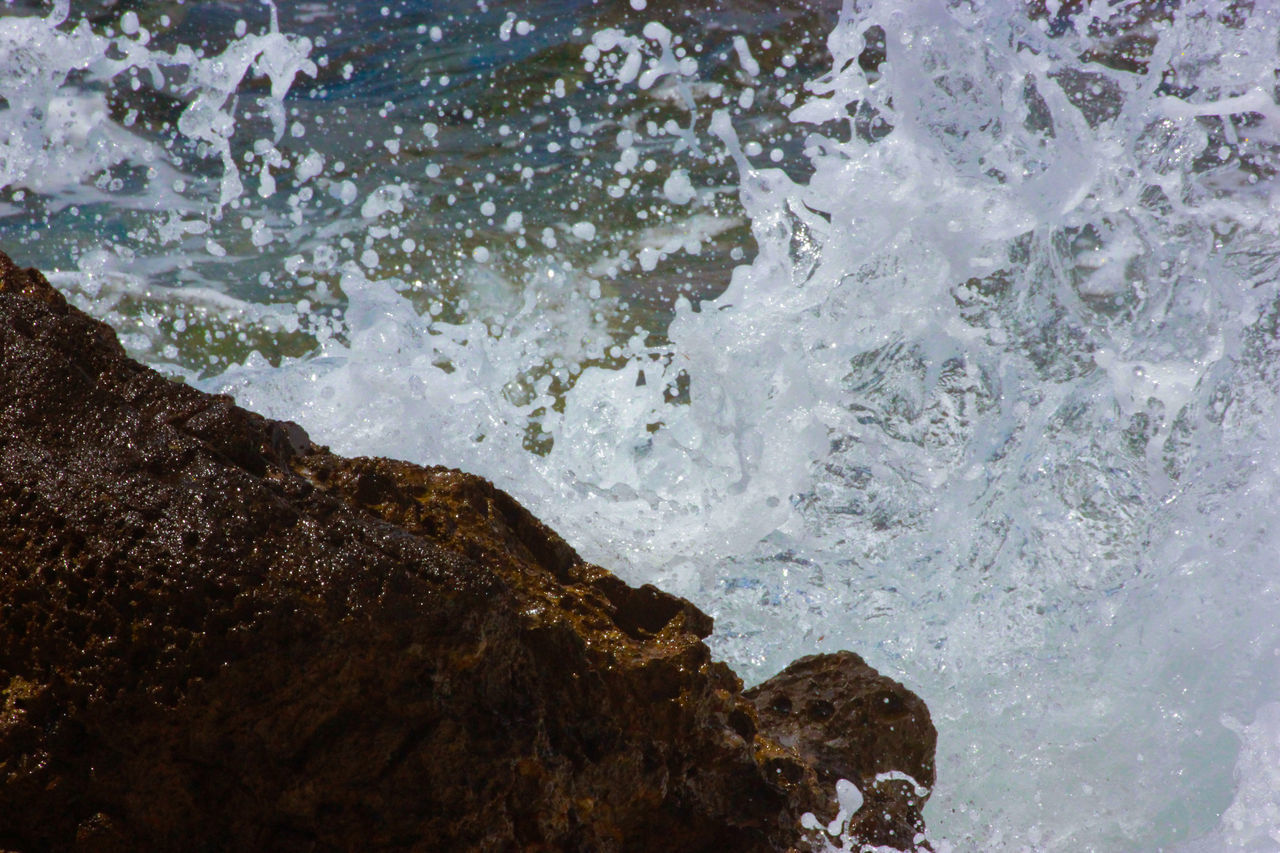 WAVES SPLASHING ON ROCKS