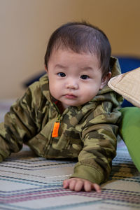 Portrait of cute baby boy sitting at home