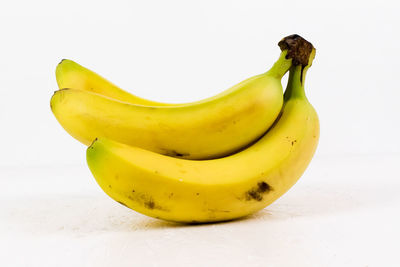 Close-up of yellow fruit against white background